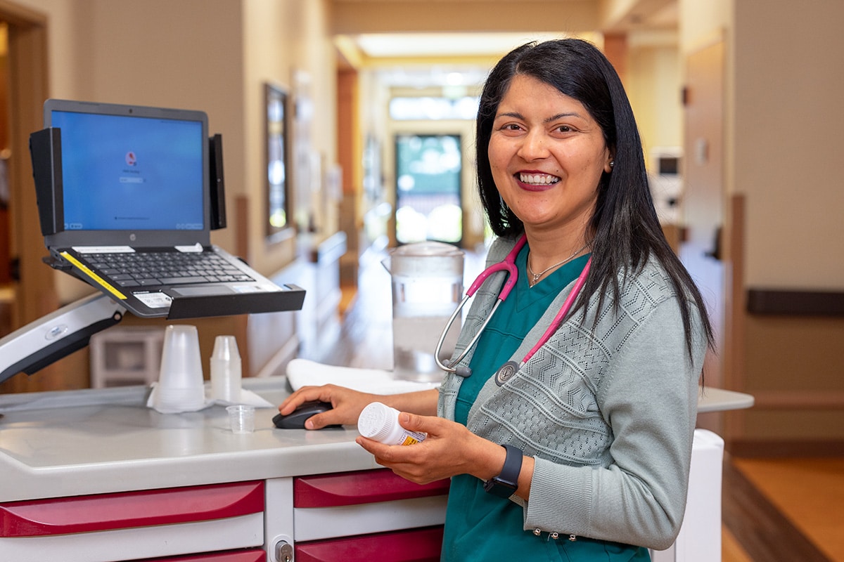 A nurse looking up medicines on the computer at Pine Ridge