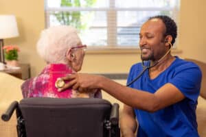A nurse checking a woman's heart beat Pine Ridge