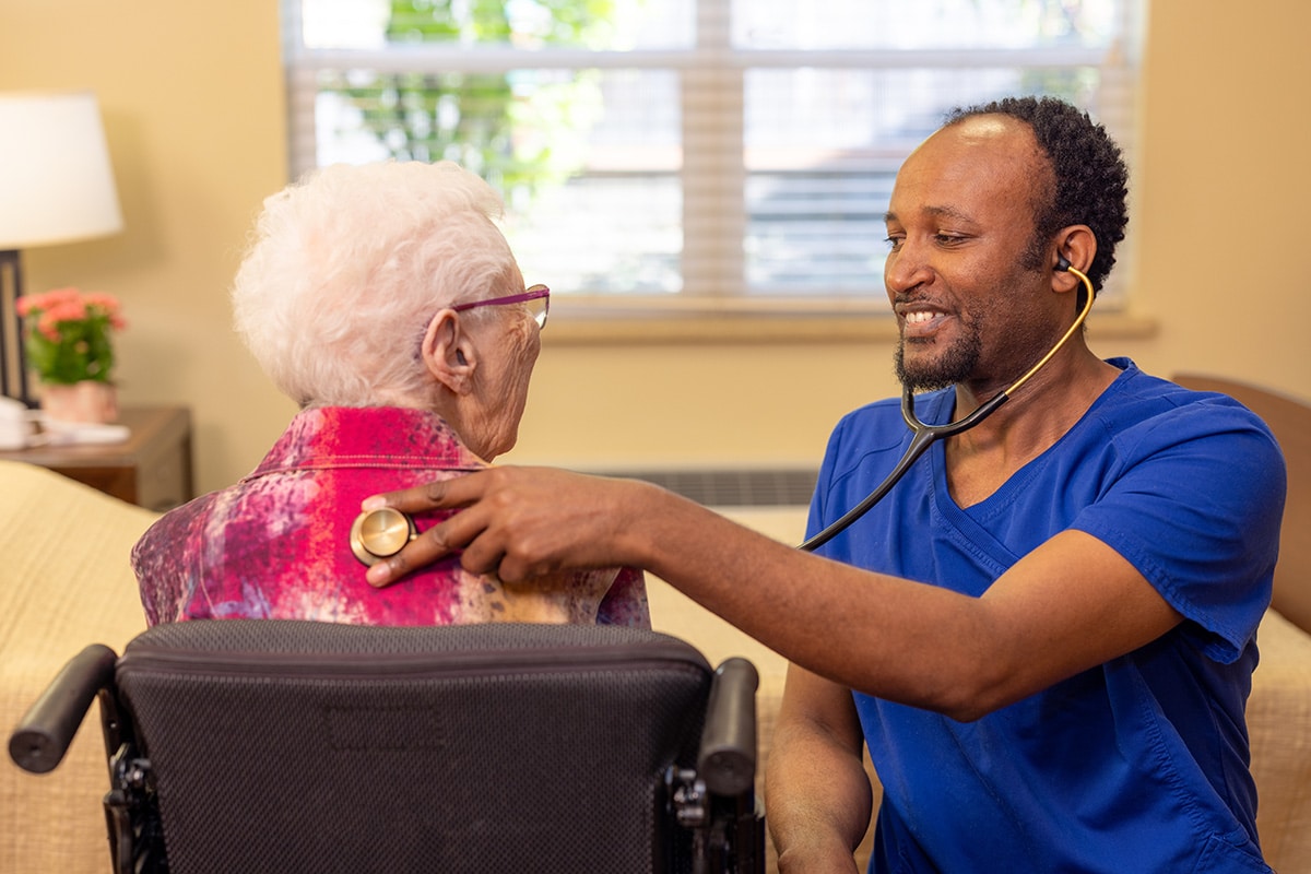 A nurse checking a woman's heart beat Pine Ridge