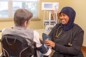 A nurse checking a woman's blood pressure Pine Ridge