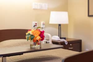 A resident's bedside with flowers at Pine Ridge