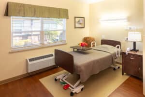 A resident's bedside with a window at Pine Ridge