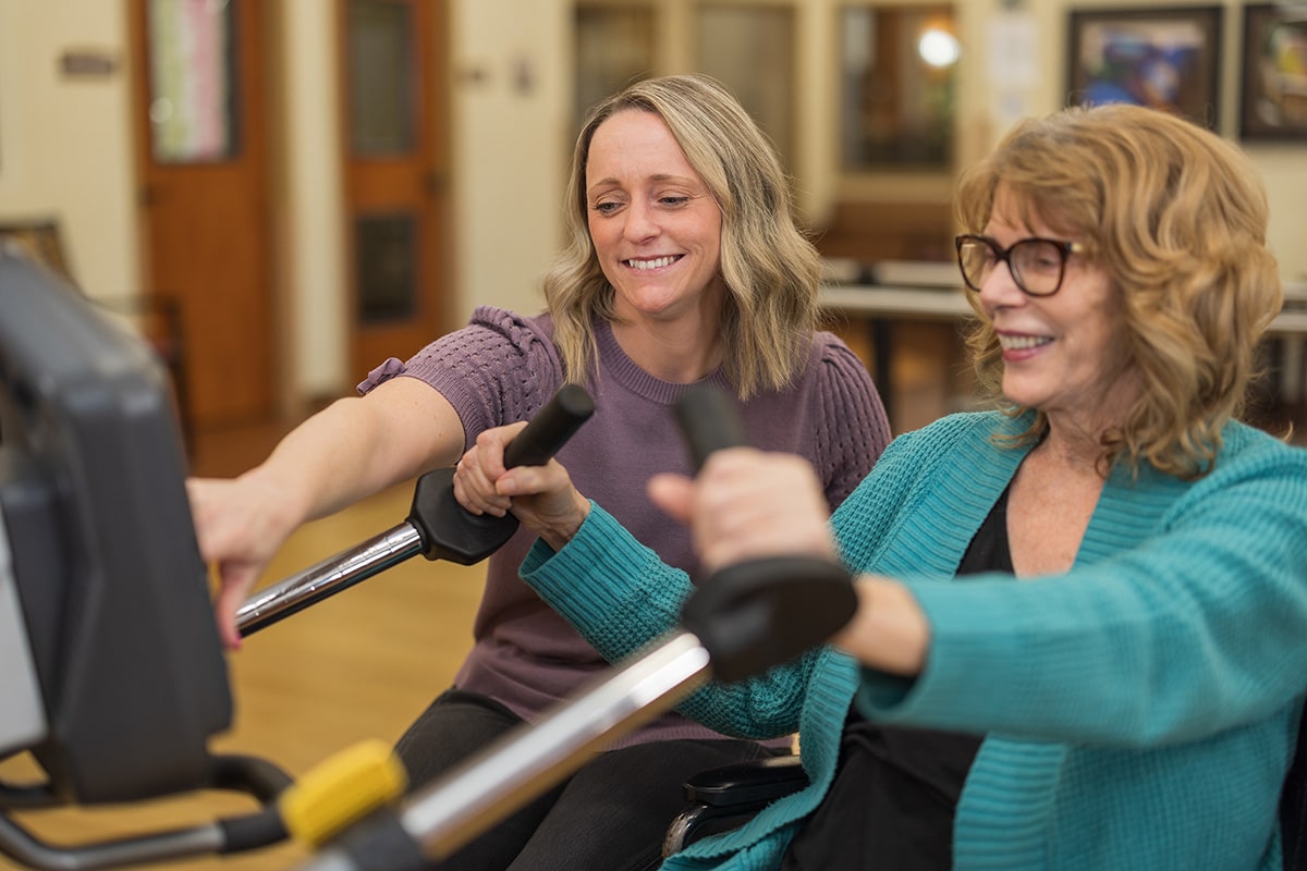 A physical therapist helping a woman at Pine Ridge