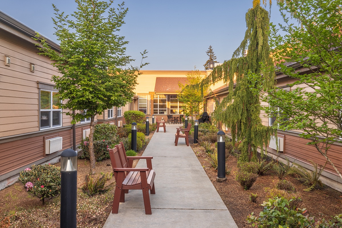 A walking path and benches outside of Pine Ridge